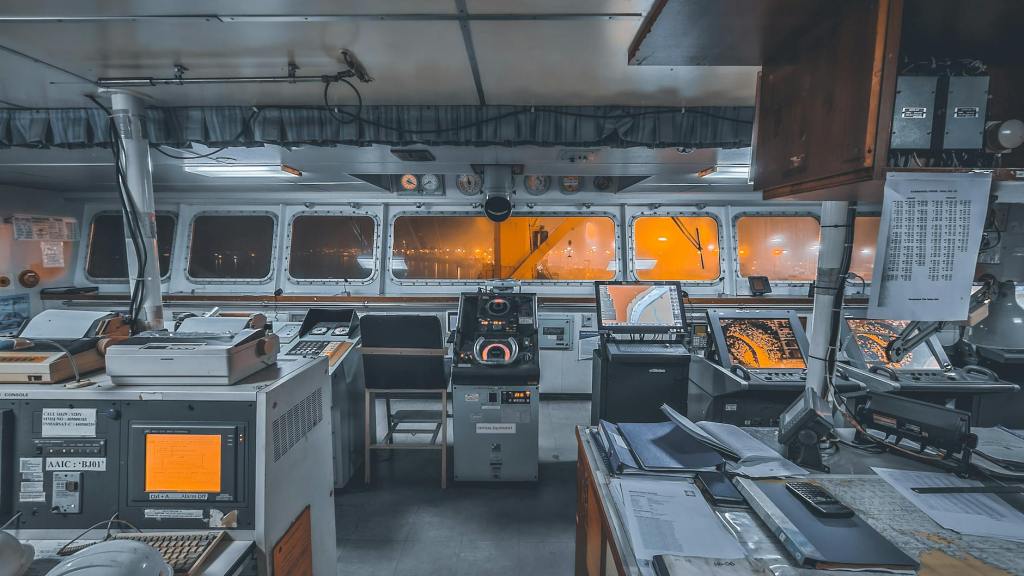 a view of the inside of a boat with a desk and computer