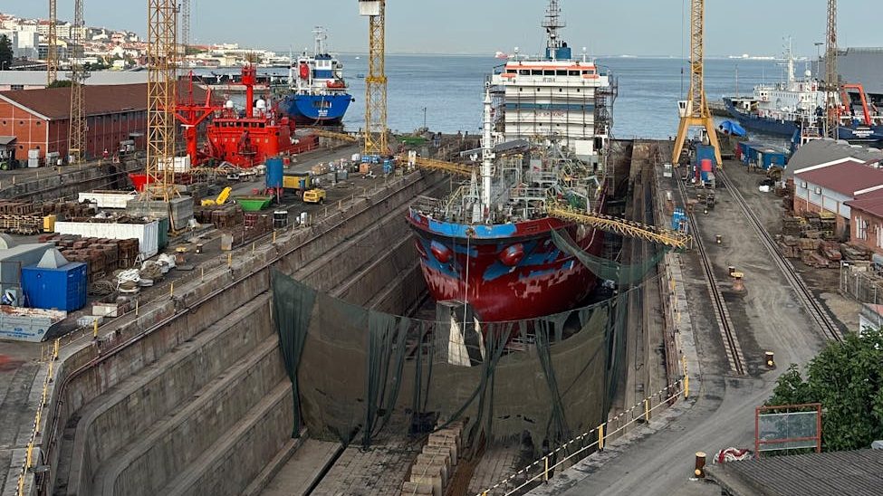 shipyard with cranes in lisbon harbor
